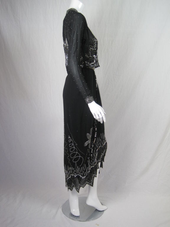 Vintage Fabrice gown.  Gorgeous, free-form beaded and sequins details.  Asymmetrical zigzag hem.  Bodice has pearls hand-sewn at regular intervals.  Long sleeve have batwing sleeves and beaded cuffs with double hook and eye closures.  Gathered waist