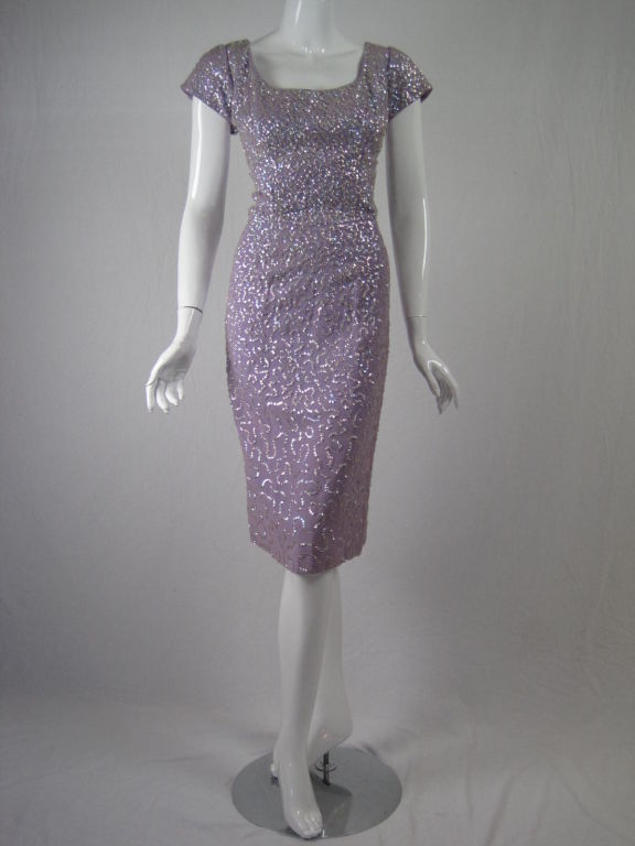 1950's cocktail party dress.  Lilac crepe covered with iridescent white sequins.  Scoop front and back neck.  Cap sleeves.  Center back metal zipper.  Lined.<br />
<br />
No size label.<br />
<br />
Measurements-<br />
<br />
Bust: 40