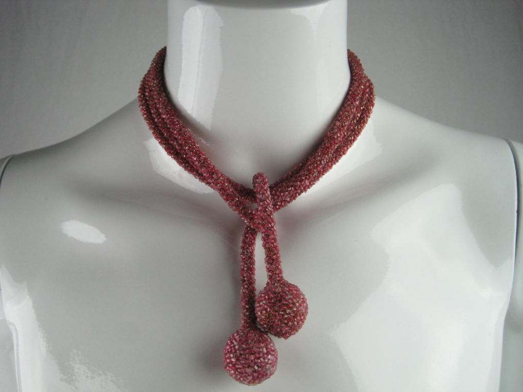 Vintage sautoir necklace made of mauve glass seed beads.  Versatile piece that can be worn in many ways, including as a belt.<br />
<br />
Measurements-<br />
<br />
Length: 54