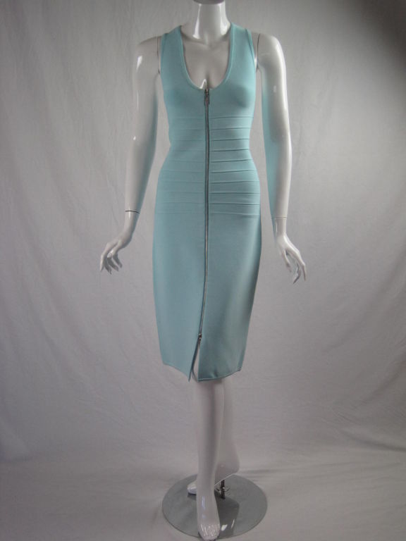 Fitted dress from Herve Leger.  Light blue stretch rayon blend.  Ribbed area through torso.  Sleeveless.  Scoop neck.  Silver-toned zip front that zips from bottom and top.  Unlined.  Shown in last photo with pink Leger shawl in another listing. 