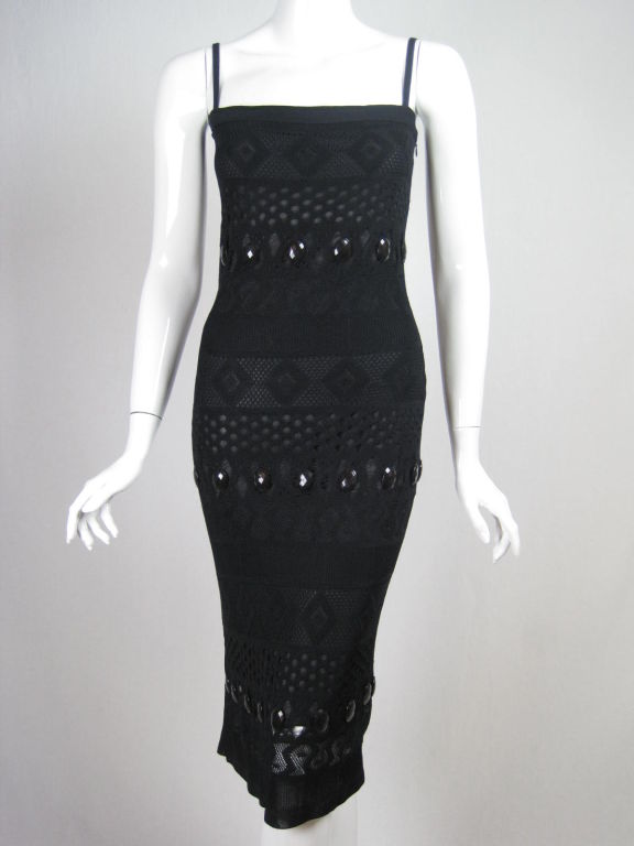 Very unique little black dress from Herve Leger.  Various types of knitting techniques that have varying levels of transparency.  Three horizontal rows of large black faceted plastic cabochons.  Spaghetti straps.  Side zip.  Fully lined.<br />
<br