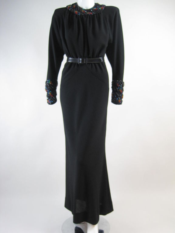 Beautiful column gown from James Galanos for famed Beverly Hills boutique, Amen Wardy.  Lightweight black wool crepe with wide beaded collar and cuffs.  Interesting and unusual beading employs black glass seed beads, black bugle beads, and