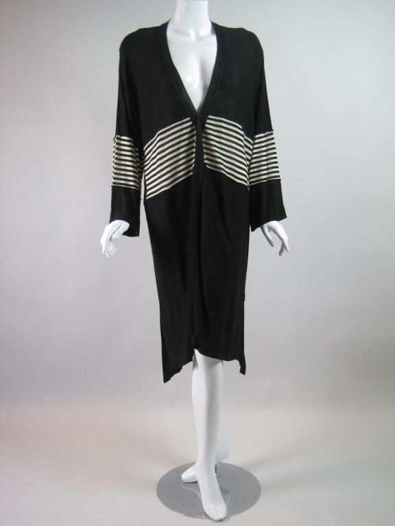 Finely knit black cardigan from Sonia Rykiel.  Narrow bands of white and black horizontal stripes around waist and forearms.  Side pockets.  No closures.  Unlined.<br />
<br />
No size label.  Designer tag is missing, but I am familiar with this