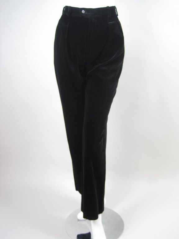 1970's high-waisted trousers from Yves Saint Laurent.  Black cotton velvet.  Pleated front.  Straight leg.  Side seam pockets.  Lapped zipper with tab waistband.  Belt loops.  Unlined.<br />
<br />
Labeled size 36.<br />
<br />
Measurements-<br