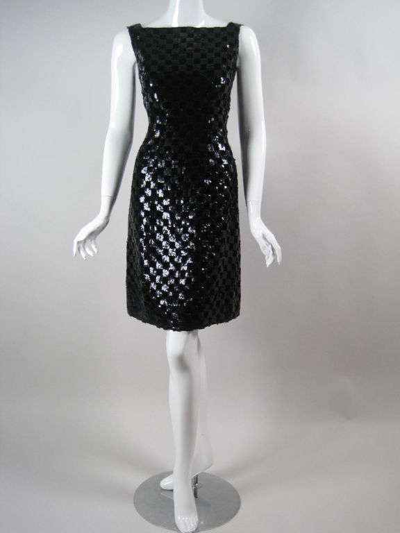 Malcolm Starr cocktail dress circa 1960's.  Black velvet adorned with black sequins in a checkerboard pattern.  Form fitting.  High, squared neckline.  Sleeveless.  Center back zip.  Fully lined.

Labeled size 40.

Measurements:

Bust: