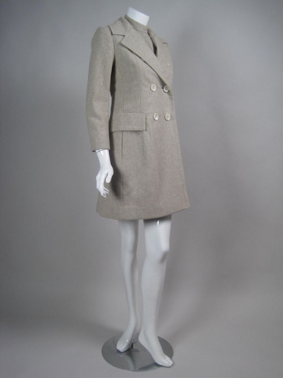 1960's Ensemble from Christian Dior that was designed during Marc Bohan's tenure there.  Oatmeal heather wool with white pearlized buttons.  Double-breasted pea coat has wide lapel, decorative hip flaps, hip pockets that are hidden in side seams,