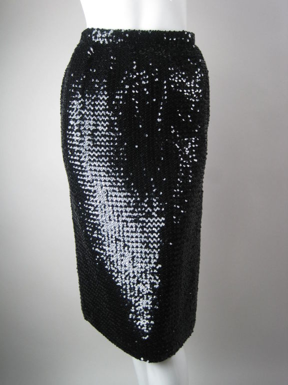 Sequin-covered pencil skirt from Emanuel Ungaro.  Single side vent.  Center back zip with hook and eye closure at waistband.  Fully lined.

Labeled size 10.

Measurements-


Waist: 26
