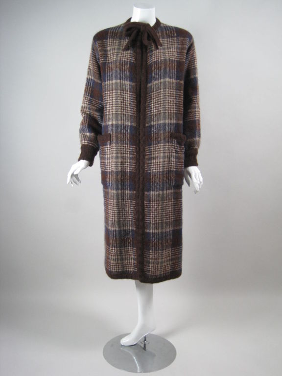 1970's sweater coat from Missoni.  Brown, blue, and tan plaid wool.  Ribbed cuffs and trim are made from brown knit.  Patch pockets at hips.  Hook and eye closure at center front neckline with tie.  Unlined.

Labeled size