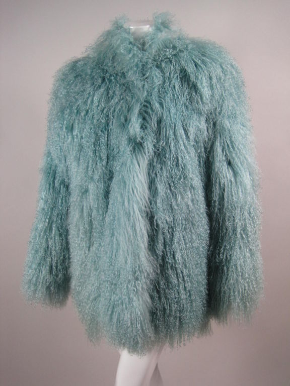 Glamorous Birger Christensen coat circa late 1980's through the 1990's.  Long-haired Mongolian lamb's fur is dyed sky blue.  Side pockets.  Round neckline.  Five heavy-duty, plastic hook and eye closures down center front.  Satin lined.

No size
