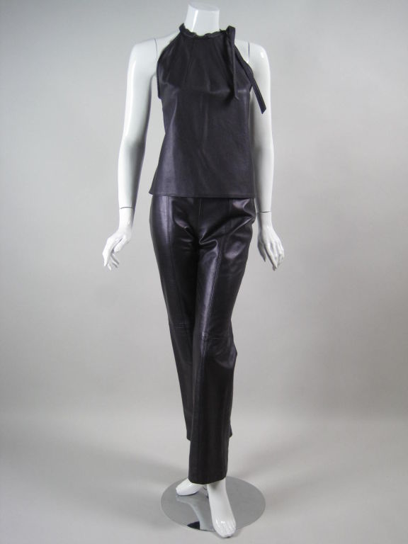 Purple leather ensemble from Herve Leger.  Sleeveless top has a round neck with radiating darts and a side tie.  Straight pants have flat front and back, top-stitching, and center back zipper.  Top is unlined.  Pants are lined.

Labeled French 38,