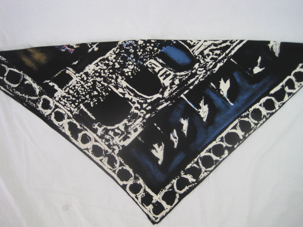 Gorgeous silk scarf from Lanvin Castillo. White, blue, purple, pink, and yellow print depicts bullfighting scene. Black ground. Loose, abstracted print has the feeling of a watercolor. Signed in lower left corner. Rolled edges.<br />
<br