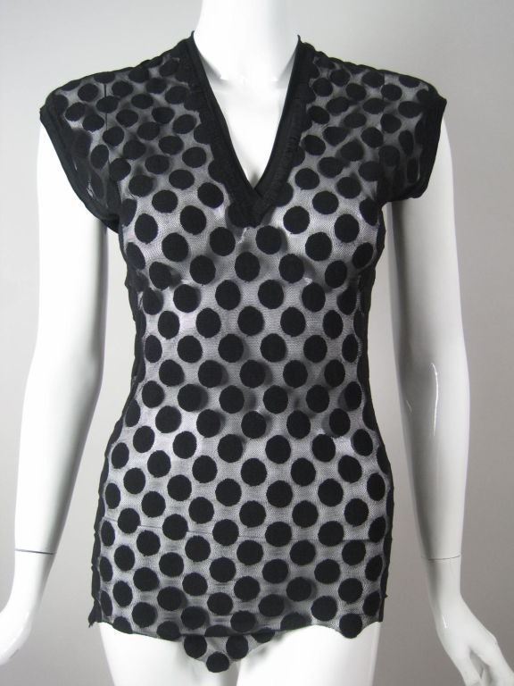 Jean Paul Gaultier polka dot mesh top.  Deep v-neck.  Cap sleeves.  Jagged, uneven hem.  Stitched detail around neckline and arm holes.  Unlined.<br />
<br />
Labeled size small.<br />
<br />
Measurements-<br />
<br />
Bust: 30-36