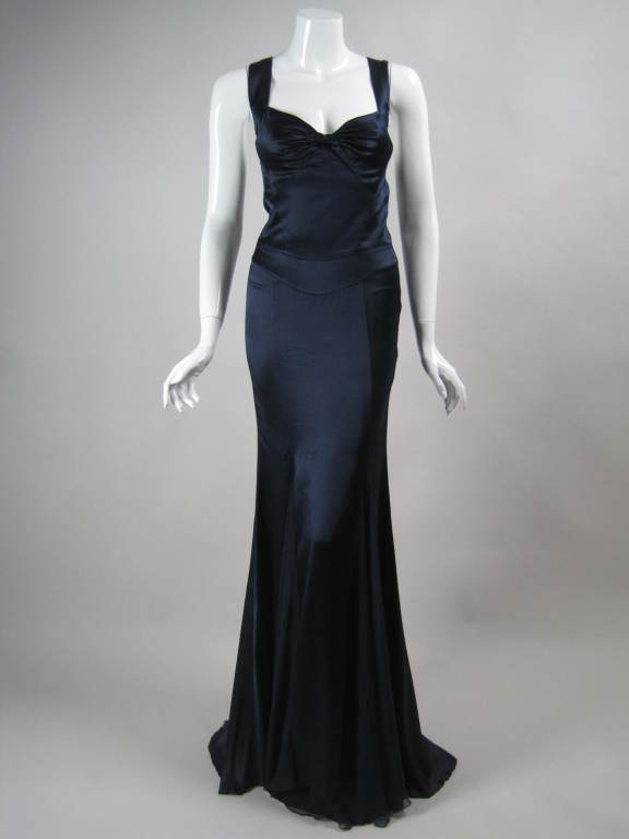 Incredibly sexy gown from Versace has a classic elegance.  Fabric at bust is gathered and twisted.  Sweetheart neckline.  Skirt has wide godets that are made out of silk chiffon.  Scoop back with crisscrossed straps.  Side invisible zipper.  Bodice