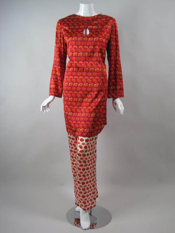 Asian-inspired outfit by Bill Blass is made of brightly-colored, printed silk charmeuse.  The tunic has a keyhole opening at center front bust, side slits, and round neckline with a faux closure at the left shoulder with a clear glass bulb fastener.
