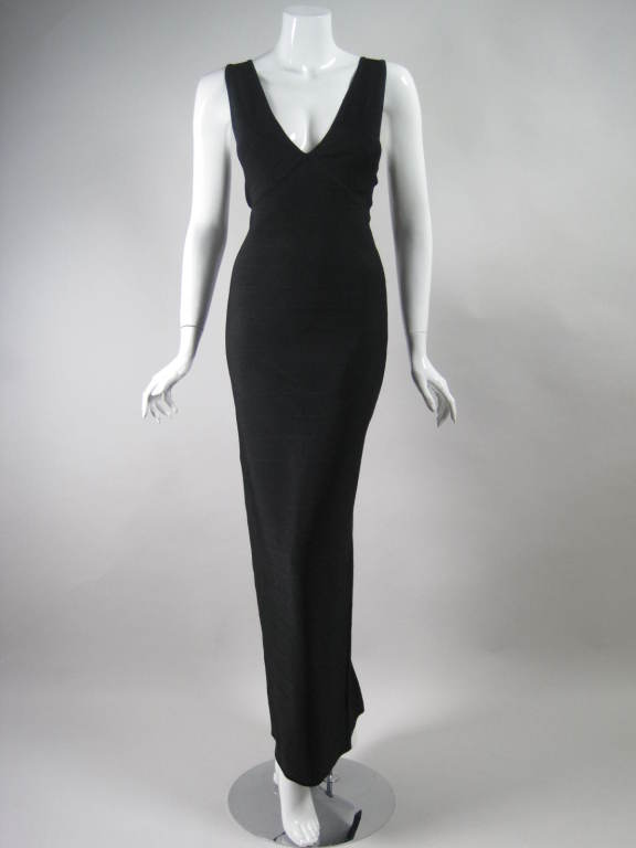 Gorgeous bandage gown from Herve Leger is made out of his signature body-slimming knit.  It has a plunging front and back v-neck.  Sleeveless.  Floor-length.  Center back slit.  Unlined.  Center back zip.  Currently the bust has pads, but they can