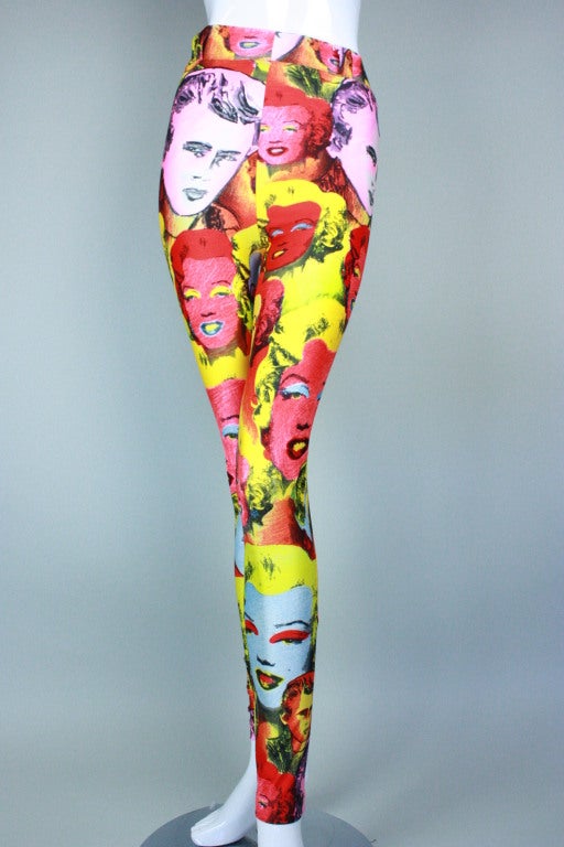 Fabulous spandex leggings from Gianni Versace date to the 1990's.  They feature an iconic Pop Art Warhol-like print with portraits of James Dean and Marilyn Monroe.  

Labeled size 40.

Waist: 22-30