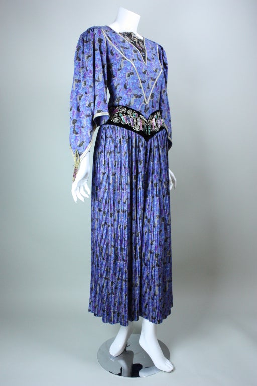 Unbelievable two-piece ensemble from Emanuel Ungaro's Couture collection is comprised of a jumpsuit and coat.  Periwinkle blue silk is printed with a pattern that is reminiscent of Gustav Klimt.  Jumpsuit has a fitted bodice with silver sequined