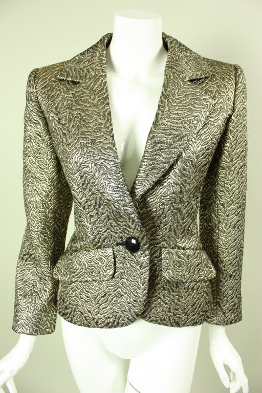 1980's through mid-1990's jacket from YSL is made of gold and black brocade that is woven with an animal print.  Single-breasted with one button center front closure.  Notch lapel.  Deep v-neck.  Two flap pockets at waist.

Labeled a size