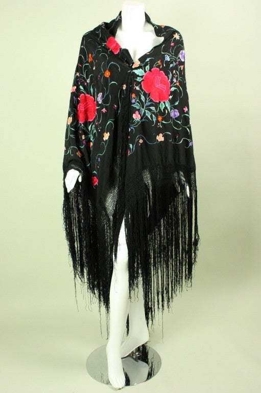 Gorgeous piano shawl dates to the 1920's.  It is made out of black silk with brightly-colored hand-embroidery throughout.  Fringed edges.


Measurements: 52" x 52"
Fringe and macramé edge: 19"