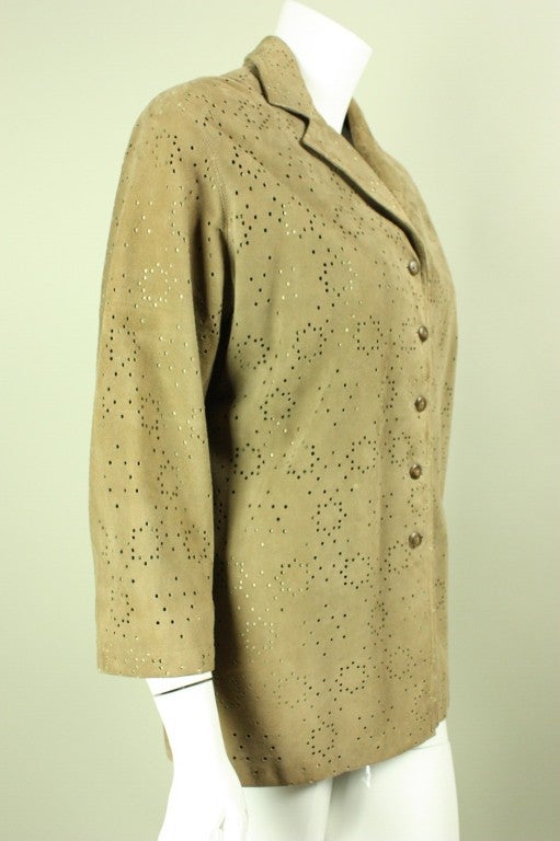 Stylish jacket from Alaia is made out of the softest taupe-colored suede that is perforated in a geometric pattern.  Turn-down collar with notch lapel.  Single-breasted with 5-button closure.  Fully lined.  

Labeled size