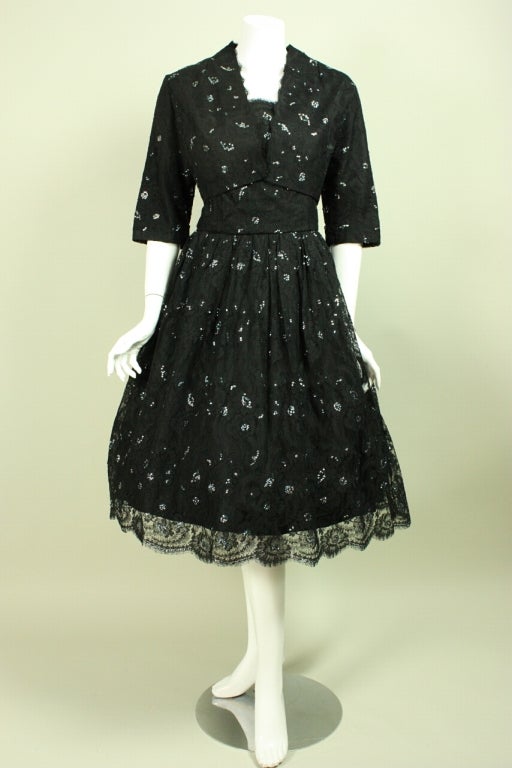 1950's dress from Vanina is a custom-made piece that was fashioned of high-quality black lace with iridescent blue sequined accents throughout.  Sleeveless dress has a squared scoop neck, fitted bodice, full skirt, and center back zipper.  Bolero