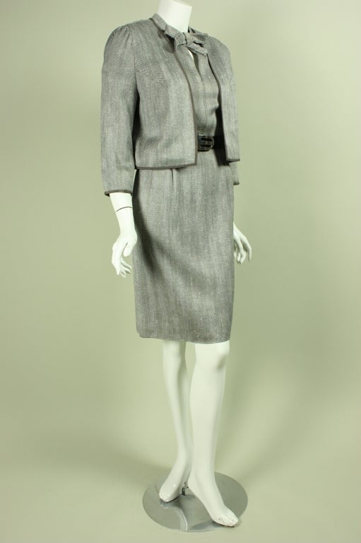 Classic dress and jacket ensemble from Hardy Aimes is made of black and white raw silk that is woven in a chevron pattern.  Fitted dress has short sleeves and a round neck with center bow and keyhole detail.  Long-sleeved jacket has no closures. 