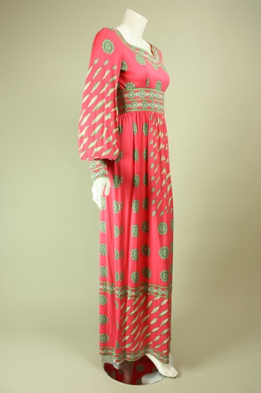Lovely maxi from Emilio Pucci and Saks Fifth Avenue dates to the 1970's.  It is made of bubblegum pink silk jersey with an iconic Pucci print.  Scoop neck.  Empire waist.  Long blouson sleeves with tapered cuff.  Unlined.  Center back