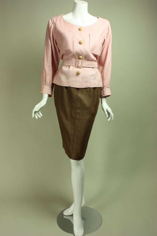 1980's YSL ensemble is made of 100% linen.  Pale pink blouse has a scoop neck, patch pockets at breast, long sleeves with button cuffs, center front button closure, and detached belt.  Chestnut brown skirt has straight cut and side zipper.  Skirt is
