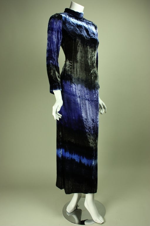 Vintage 1970's gown from Hanae Mori is made of tie-dyed crushed velvet in shades of blue, black, and purple.  Mock neck.  Long sleeves.  Center back zipper.  Fully lined.

Labeled size 6.
