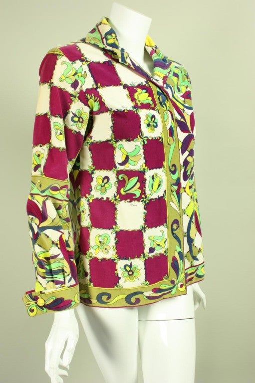 Emilio Pucci velveteen blouse from Saks Fifth Avenue features an iconic bold, colorful print.  Turn down collar.  Long sleeves with french cuffs.  Center front covered button closure.  Unlined.