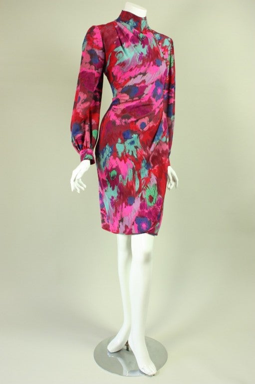 Colorful faux-wrap dress from Ungaro dates to the 1980's.  It is made of printed silk that is reminiscent of ikat.  Mock neck with gathering at the right shoulder that releases softly into the bust.  Left hip gather releases downwards.  Long sleeves