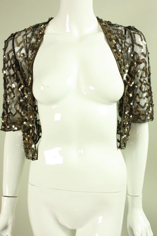 Evening bolero is made of black netting with sequined geometric and floral design.  Labeled 