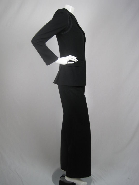 MARKED DOWN FROM $525!

Black trouser suit with black and gray ribbed inserts at armhole.  Jacket has notch lapel, three button front, two waist flap pockets, one breast pocket, double back vent, and four decorative buttons at cuffs.  Fully lined.