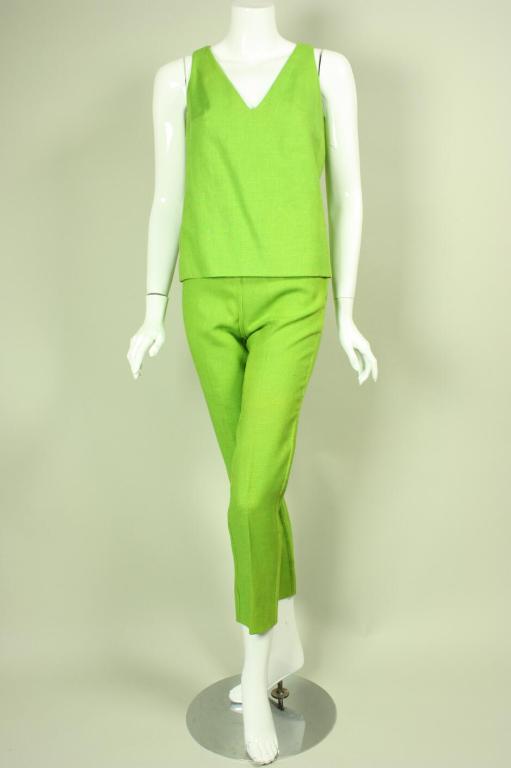 Two-piece ensemble from Rudi Gernreich is made of lime green linen.  Sleeveless blouse has v-neck, bust darts, and a center back zipper.  Ankle-length pants sit at the waistline and are tapered.

No size label, but I estimate it to be a size