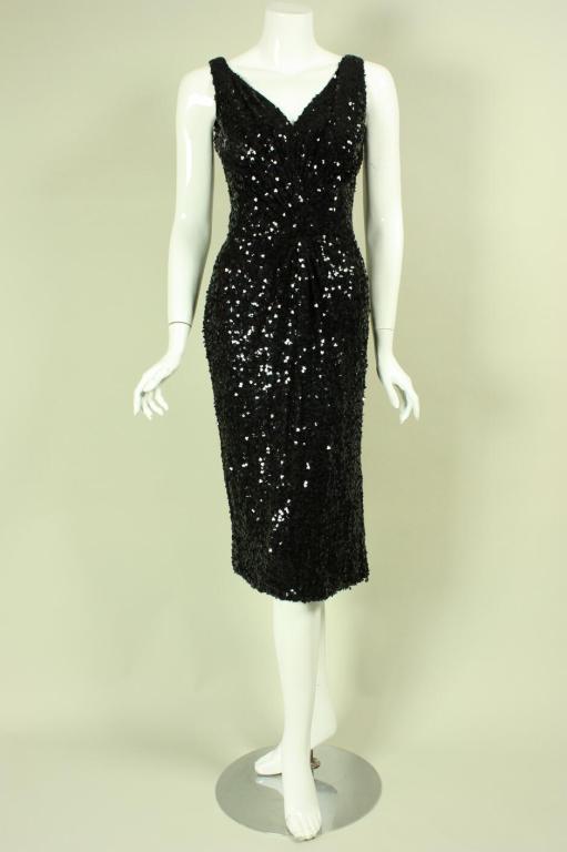 Stunning cocktail dress from Ceil Chapman dates to the 1950's.  It is fully covered with black sequins and has a scoop front and back neck.  Twist detail at front side waist.  Fully lined.  Center back zipper.

Measurements-

Bust: 36