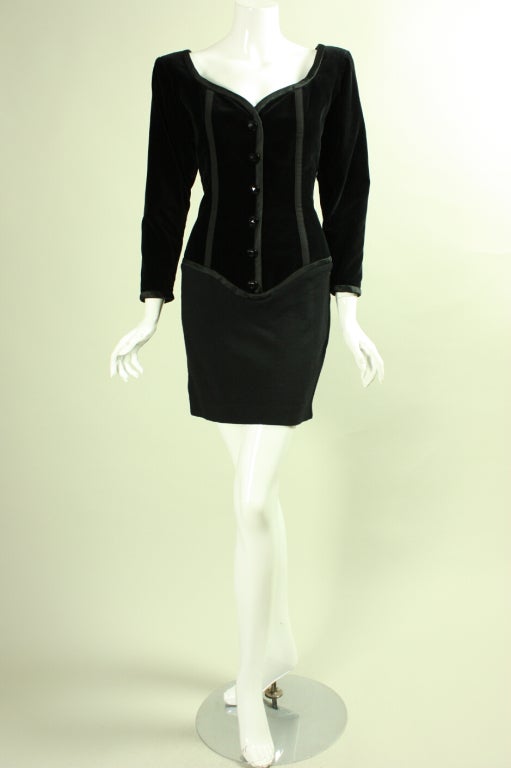 Vintage cocktail dress from Yves Saint-Laurent dates to the late 1980's through 1990's.  The fitted bodice features a sweetheart neckline, satin trim, and velvet panels that are separated by grosgrain ribbon.  Wool crepe skirt is above knee-length. 