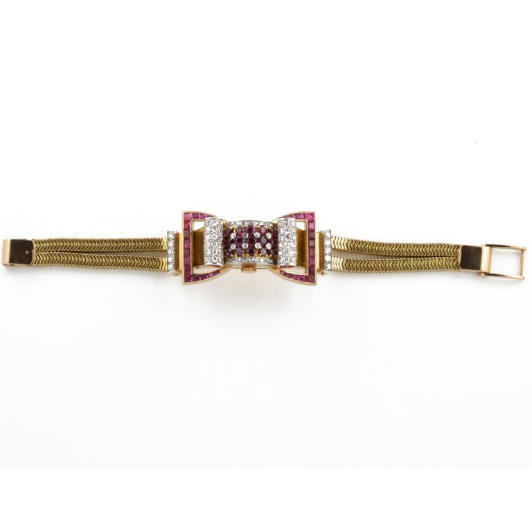 A ruby and diamond set lady's watch in the form of a bow. Mounted in 18kt yellow gold and platinum.