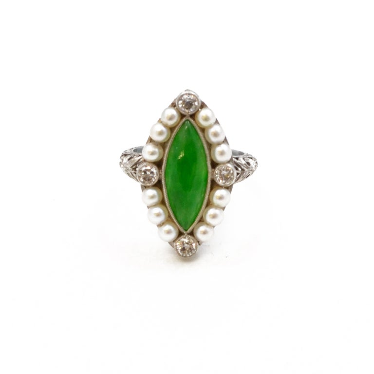 A marquise jade ring, set with diamonds and pearls. Mounted in platinum.