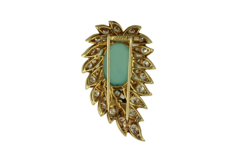 18K Yellow Gold Brooch with diamonds and a cabouchon oval Turquoise. Diamond total carat weight: 3.70.