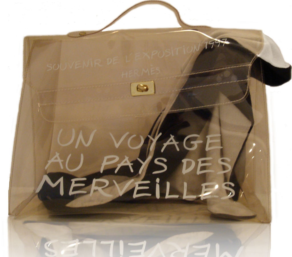 Souvenir Exposition Limited Edition- Transparent tan color bag with gold tone metal turn hardware.