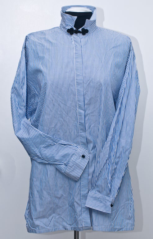 This shirt is made of very soft 100% cotton and has a masculine feel with feminine touches. This shirt has a  Mandarin frog neck closure and 1 at each cuff. It sports 2 wide side slits and closes with real mother of pearl buttons.
(Yes, I know it