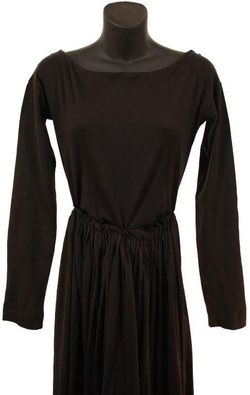 This Gigli dress is black 100% Cotton with elastic waist and scoop neck.  It has long fitted sleeves and has a full skirt.