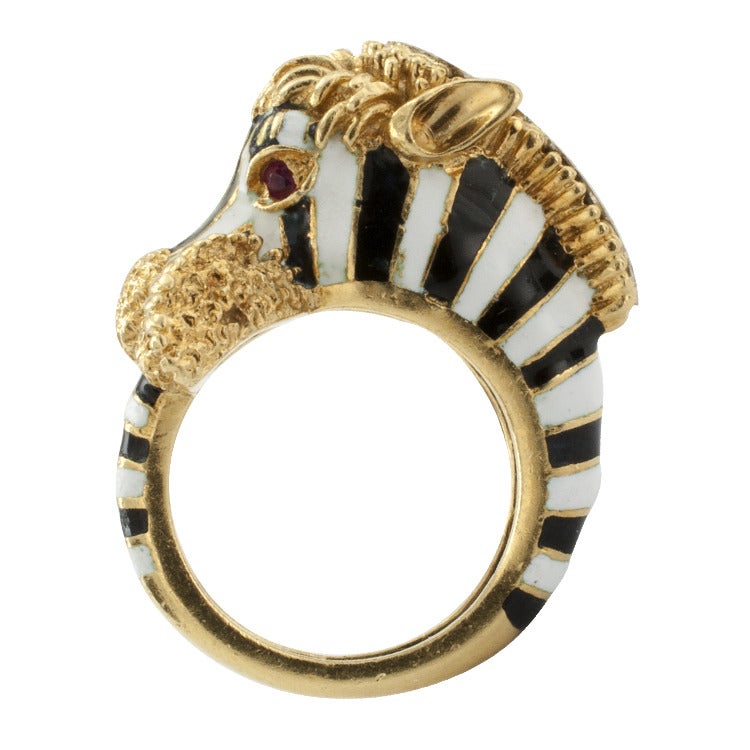 Designed as a three dimensional zebra head and tail, crafted in black and white enamel with gold accents, the mane set with diamonds, ruby eyes.  In 18kt yellow gold.  SIZE 5 1/2