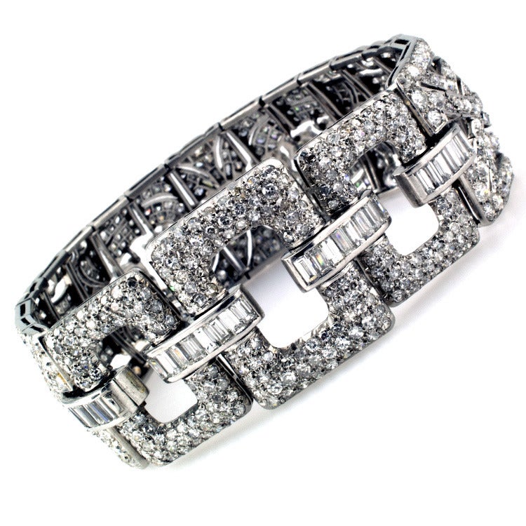 This great bracelet with its flexible design features three large open links near the clasp, connected to a series of geometric links all set with diamonds totaling approximately 18.0 carats, mounted in platinum. (VS - SI clarity, H - L color)