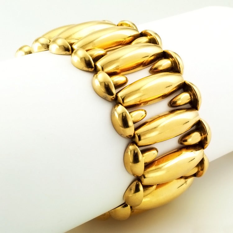 This Fabulous, Chunky Gold Retro Bracelet, Circa 1940 is 
elegantly shaped, with polished gold links that express their own aesthetic,
1 1/4 inches wide, 8 inches long, in 18kt gold. Possibly Austrian.