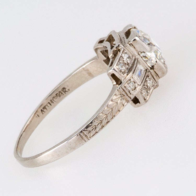 0.98 Carat Art Deco Diamond Engagement Ring, Circa 1925

The geometric deign centers upon a very nice old European-cut diamond weighing 0.98ct (G, VS2  EGL cert), flanked by a pair of baguette diamonds and ten round diamonds totaling approximately