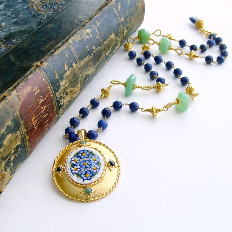 Cobalt blue faceted lapis Lazuli beads with their sprinkling of pyrite freckles set a rich and elegant  mood when paired with Spring green hand-coiled chrysoprase nuggets.  A beautiful micro mosaic pendant of Forget-Me Not flowers emulates the