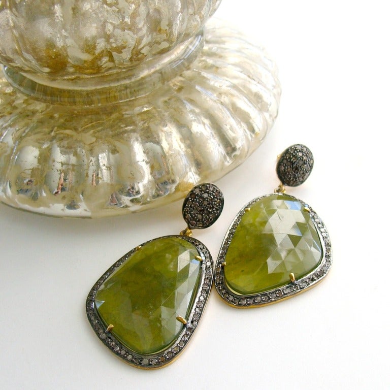 Stunning, luxe and unique cypress green serpentine faceted slices post-style earrings encircled by pave diamonds will put you well in advance of the next fashion trend for Fall 2014.  This unexpected gemstone with itâ??s unique color is the perfect