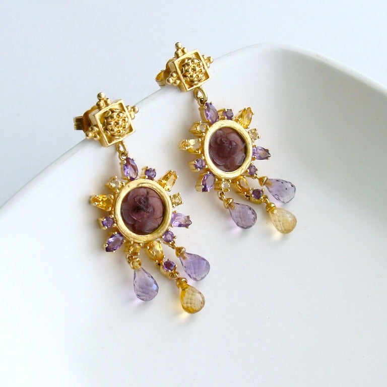 Diminutive Venetian flower intaglios have been surrounded by a delicate explosion of golden citrine and amethyst stones set around the bezel while lovely micro faceted teardrops sway gently below the design.  These post-style earrings with their