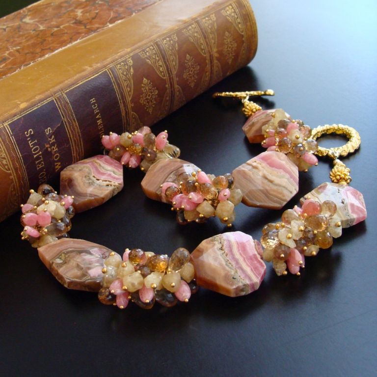 Unique Missoni-striped rhodochrosite slices in honeysuckle pink, bamboo, coffee liqueur and nougat colors are juxtaposed with generous frills of champagne citrine briolettes, andalusite rondelles, Herkimer diamond nuggets and dainty rhodochrosite
